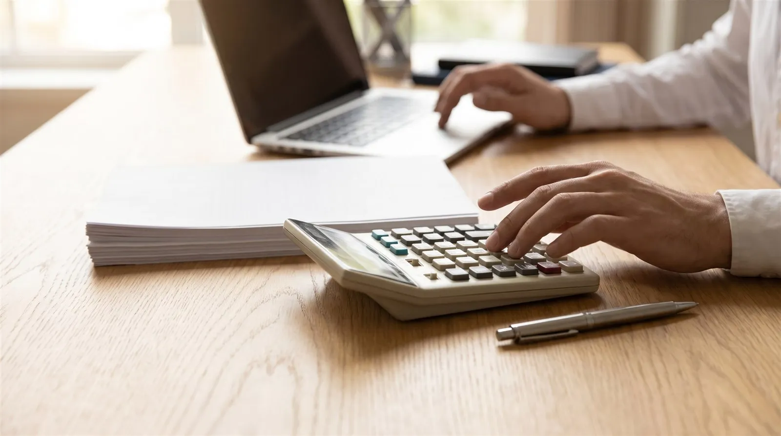 A close-up of a calculator resting on a client's financial documents